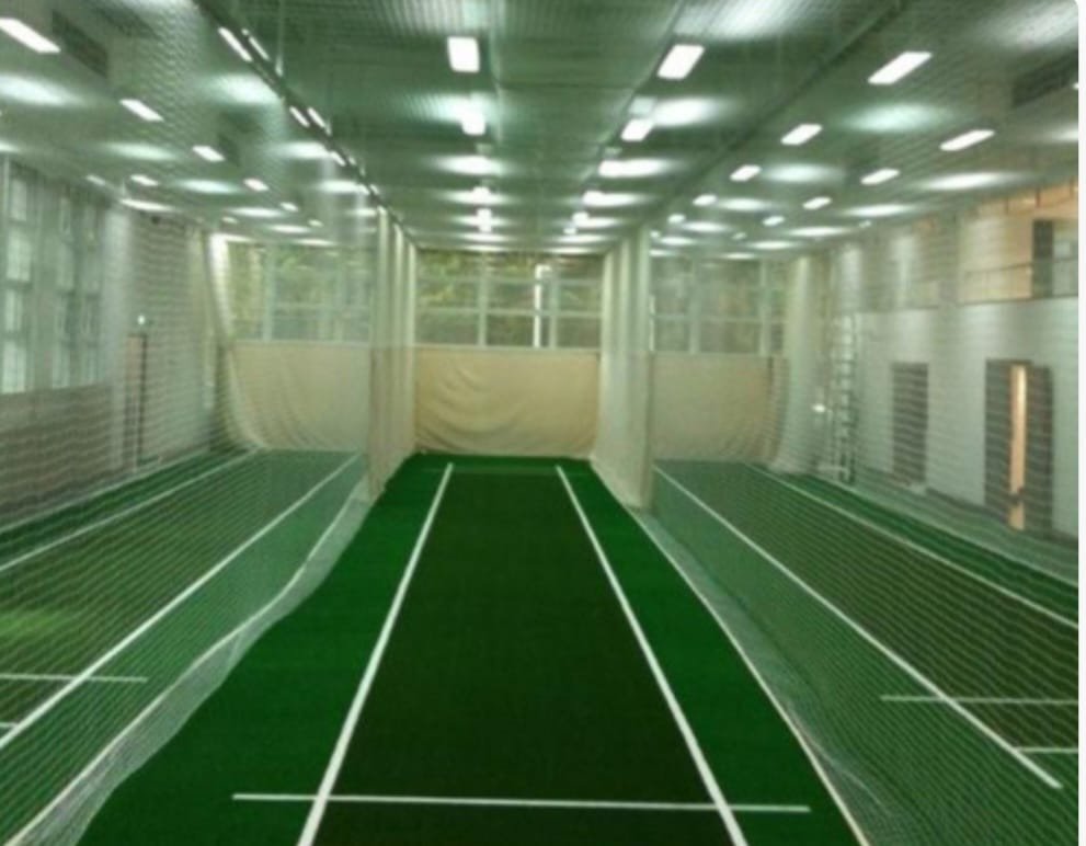 Indoor cricket practice area enclosed with netting