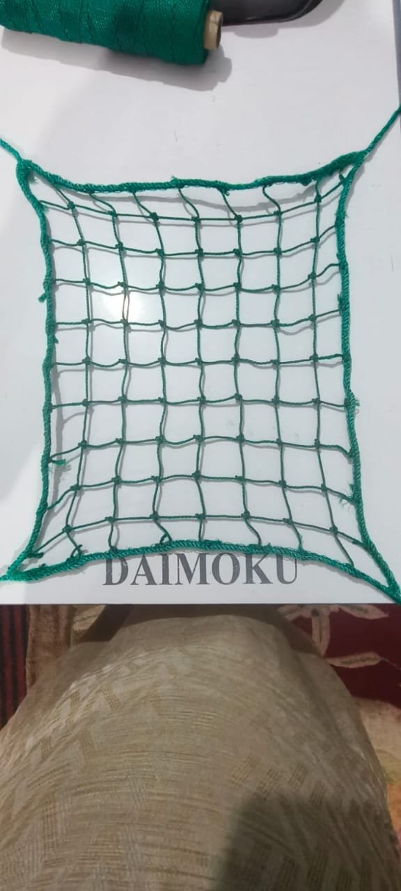 Close detail of a knotted green safety net sample